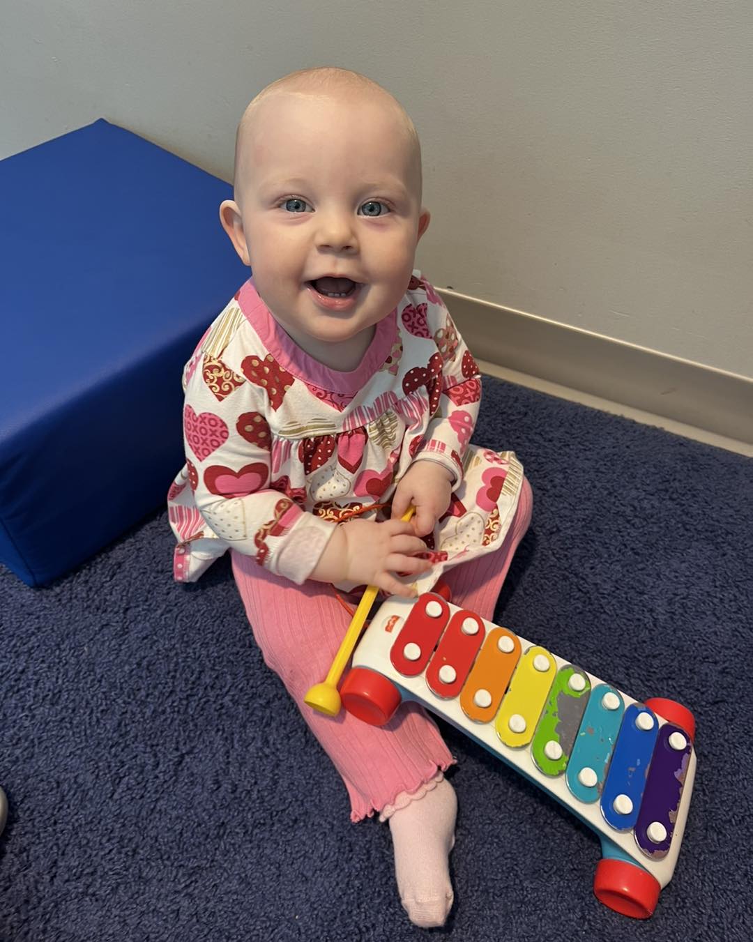Infant enjoying music enrichment and sensory play with a xylophone at Ardent Preschool & Daycare – Clift Farms in Madison, Alabama.