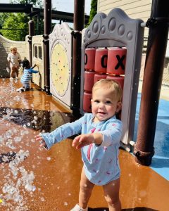 Little kid playing on splash pad at Ardent Preschool & Daycare Trace Crossings hoover location during summer program.