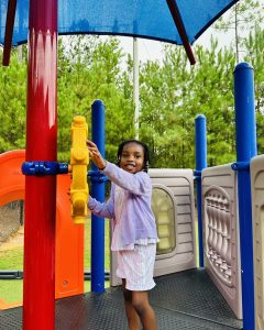 Preschooler enjoying imaginative outdoor fun at Ardent Preschool & Daycare – Trace Crossings campus